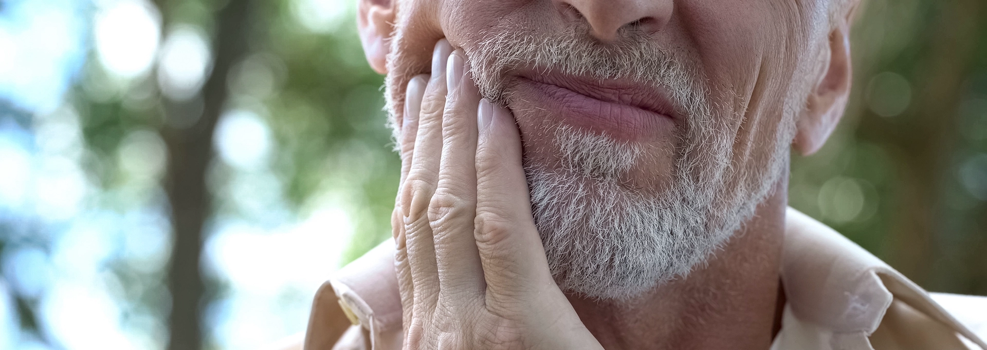 senior man holding jaw in pain-cropped