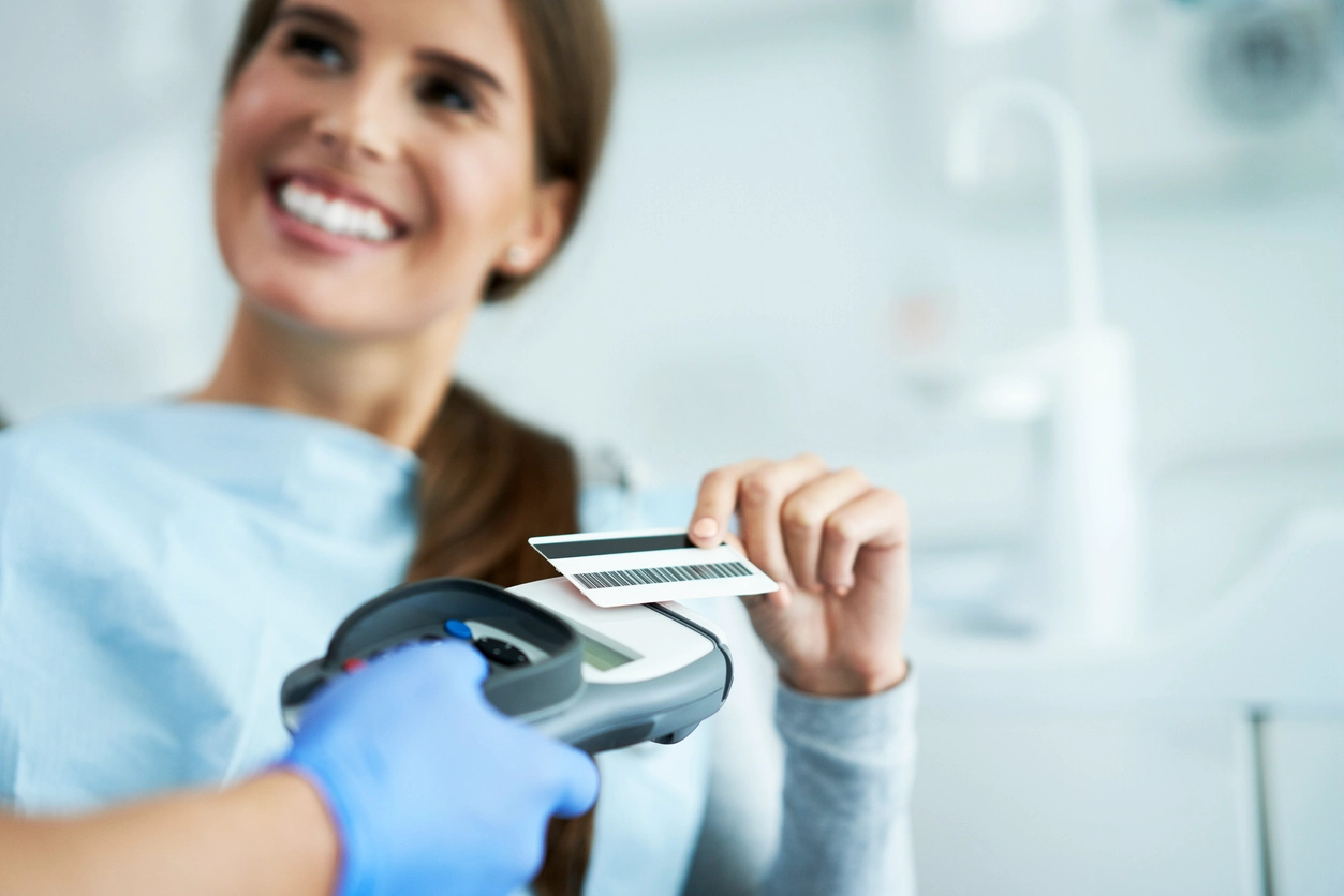woman happily paying dental visit