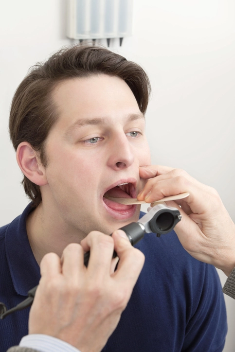 young man getting screened for dental problems